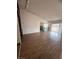 Open living room featuring hardwood floors, a built-in shelf, and access to the kitchen at 904 Dianne Dr, Boulder City, NV 89005