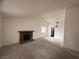 Open-concept living room featuring a fireplace, neutral paint, and a view of other rooms at 904 Dianne Dr, Boulder City, NV 89005