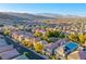 Wide aerial shot of a community with mountain views, landscaping, and varied housing at 9144 Epworth Ave, Las Vegas, NV 89148