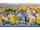 Scenic aerial view of a residential neighborhood, showcasing tile roofs and green spaces at 9144 Epworth Ave, Las Vegas, NV 89148