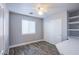 Bedroom with wood-look flooring, built-in shelves, and closet with sliding doors at 9144 Epworth Ave, Las Vegas, NV 89148