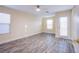 Bright bedroom with wood-look flooring, natural light, ceiling fan, and door to backyard at 9144 Epworth Ave, Las Vegas, NV 89148