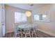 Bright dining area featuring a round table, six chairs, and a modern light fixture at 9144 Epworth Ave, Las Vegas, NV 89148