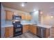 Modern kitchen with stainless steel appliances, wood cabinets, and light backsplash at 9144 Epworth Ave, Las Vegas, NV 89148