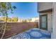 Cozy patio area with blue patterned rug, brick fence, and secure door at 9144 Epworth Ave, Las Vegas, NV 89148