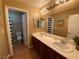 Bathroom featuring double sinks, vanity with generous counter space, and separate toilet at 9364 Olympia Falls Ave, Las Vegas, NV 89149