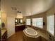 Bathroom features a soaking tub, tiled floors, and a double sink vanity at 9364 Olympia Falls Ave, Las Vegas, NV 89149