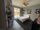 Cozy bedroom with a sliding glass door to the backyard patio and gray wood flooring at 9364 Olympia Falls Ave, Las Vegas, NV 89149