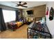 A bedroom with decor, a ceiling fan, and a large window that allows for natural light at 9364 Olympia Falls Ave, Las Vegas, NV 89149