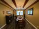 Formal dining room with dark wood table, decorative chandelier, and matching wood floors at 9364 Olympia Falls Ave, Las Vegas, NV 89149