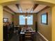 A dining room featuring a wooden dining table, a hanging light fixture, and tasteful decor at 9364 Olympia Falls Ave, Las Vegas, NV 89149