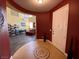 Elegant entryway with a decorative tiled floor, red accent walls, and open view to living spaces at 9364 Olympia Falls Ave, Las Vegas, NV 89149