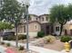 Charming two-story home featuring manicured landscaping, stone accents, and a welcoming front entrance at 9364 Olympia Falls Ave, Las Vegas, NV 89149