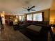 A living room featuring hardwood floors, a comfortable sectional sofa, and backyard views from the windows at 9364 Olympia Falls Ave, Las Vegas, NV 89149