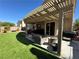 Enjoy outdoor living under this covered patio, complete with stylish furniture and a barbecue area at 9364 Olympia Falls Ave, Las Vegas, NV 89149