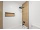 Detailed view of the modern tiled shower, with a built-in shelf and rainfall shower head at 9795 La Cienega St, Las Vegas, NV 89183