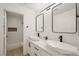 Modern bathroom with double sinks, white countertops, and a tiled walk-in shower at 9795 La Cienega St, Las Vegas, NV 89183