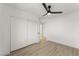 Bright bedroom featuring a ceiling fan, closet, and light hardwood floors at 9795 La Cienega St, Las Vegas, NV 89183