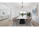 Bright dining room with a modern chandelier, marble table, and sliding glass doors leading to a pool at 9795 La Cienega St, Las Vegas, NV 89183