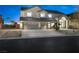 Two-story home with three-car garage, neutral color palette, and a well-manicured lawn at 9795 La Cienega St, Las Vegas, NV 89183