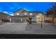 Two-story home showcasing a three car garage, manicured yard and large front entrance at 9795 La Cienega St, Las Vegas, NV 89183