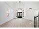 Grand foyer with high ceilings, arched windows, modern chandelier and wood-look floors at 9795 La Cienega St, Las Vegas, NV 89183