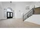 Welcoming foyer with high ceilings, an elegant chandelier, black staircase, and wood-look floors at 9795 La Cienega St, Las Vegas, NV 89183