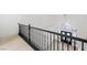 View from upstairs hallway, with black railing overlooking the entryway at 9795 La Cienega St, Las Vegas, NV 89183