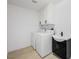 Functional laundry room with white cabinetry, modern sink and stylish black hardware at 9795 La Cienega St, Las Vegas, NV 89183