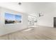 Bright and airy living room with large windows offering picturesque views, complemented by modern ceiling fan at 9795 La Cienega St, Las Vegas, NV 89183