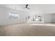 Open-concept living room leading into the kitchen, with sleek wood floors and recessed lighting at 9795 La Cienega St, Las Vegas, NV 89183