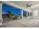 Covered patio with columns and a ceiling fan overlooks the pool and landscaped backyard at 9795 La Cienega St, Las Vegas, NV 89183