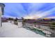 Spacious outdoor patio with a small pool, metal railing, and city views at sunset at 9795 La Cienega St, Las Vegas, NV 89183