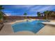 A refreshing in-ground pool with baja shelf and tiled spa in a landscaped backyard at 9795 La Cienega St, Las Vegas, NV 89183