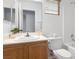 Bathroom featuring a wood vanity with a sink, a toilet, and blinds on the window at 10651 Streamside Ave, Las Vegas, NV 89129