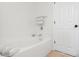 Bright bathroom featuring a soaking tub, white tile, chrome fixtures and a linen closet at 10651 Streamside Ave, Las Vegas, NV 89129