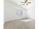 Bedroom with carpet, ceiling fan, and a window allowing natural light with a view at 10651 Streamside Ave, Las Vegas, NV 89129