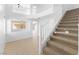 Bright foyer featuring staircase, large windows, and tile flooring at 10651 Streamside Ave, Las Vegas, NV 89129