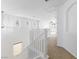 Bright upstairs hallway with carpet floors, white railing, several windows and a ceiling fan at 10651 Streamside Ave, Las Vegas, NV 89129