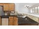 A kitchen with wood cabinets and stainless steel appliances, including a double sink and dishwasher at 10651 Streamside Ave, Las Vegas, NV 89129