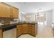 The kitchen features wood cabinets, a stainless steel dishwasher, and tile countertops and backsplash at 10651 Streamside Ave, Las Vegas, NV 89129