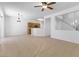 An open-concept living room with tile flooring with open view to kitchen and stairway at 10651 Streamside Ave, Las Vegas, NV 89129