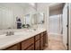 Bright bathroom features a double sink vanity and a shower/tub combination at 11165 Robin Park Ave, Las Vegas, NV 89138