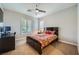 This bedroom features a ceiling fan, a bed, a window with shutters, and a desk with computer at 11165 Robin Park Ave, Las Vegas, NV 89138