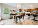 Open dining area next to kitchen features tile floors and stylish lighting at 11165 Robin Park Ave, Las Vegas, NV 89138