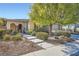 Charming single-story home featuring desert landscaping, stone accents, and an inviting arched entryway at 11165 Robin Park Ave, Las Vegas, NV 89138