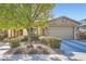 Beautiful single-story home showcases stone accents, a two-car garage, and mature desert landscaping at 11165 Robin Park Ave, Las Vegas, NV 89138