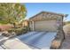 Single-story home features stone accents, a two-car garage, and a concrete driveway at 11165 Robin Park Ave, Las Vegas, NV 89138