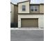 Exterior showing large garage door of a new construction home with paver driveway at 11394 Ethereal Landing Ave, Las Vegas, NV 89138