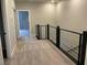 Upstairs hallway with modern railing and neutral carpet at 11394 Ethereal Landing Ave, Las Vegas, NV 89138